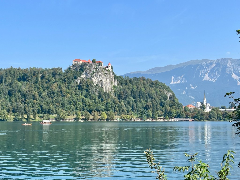 view of Bled Castle from shoreline of Lake Bled