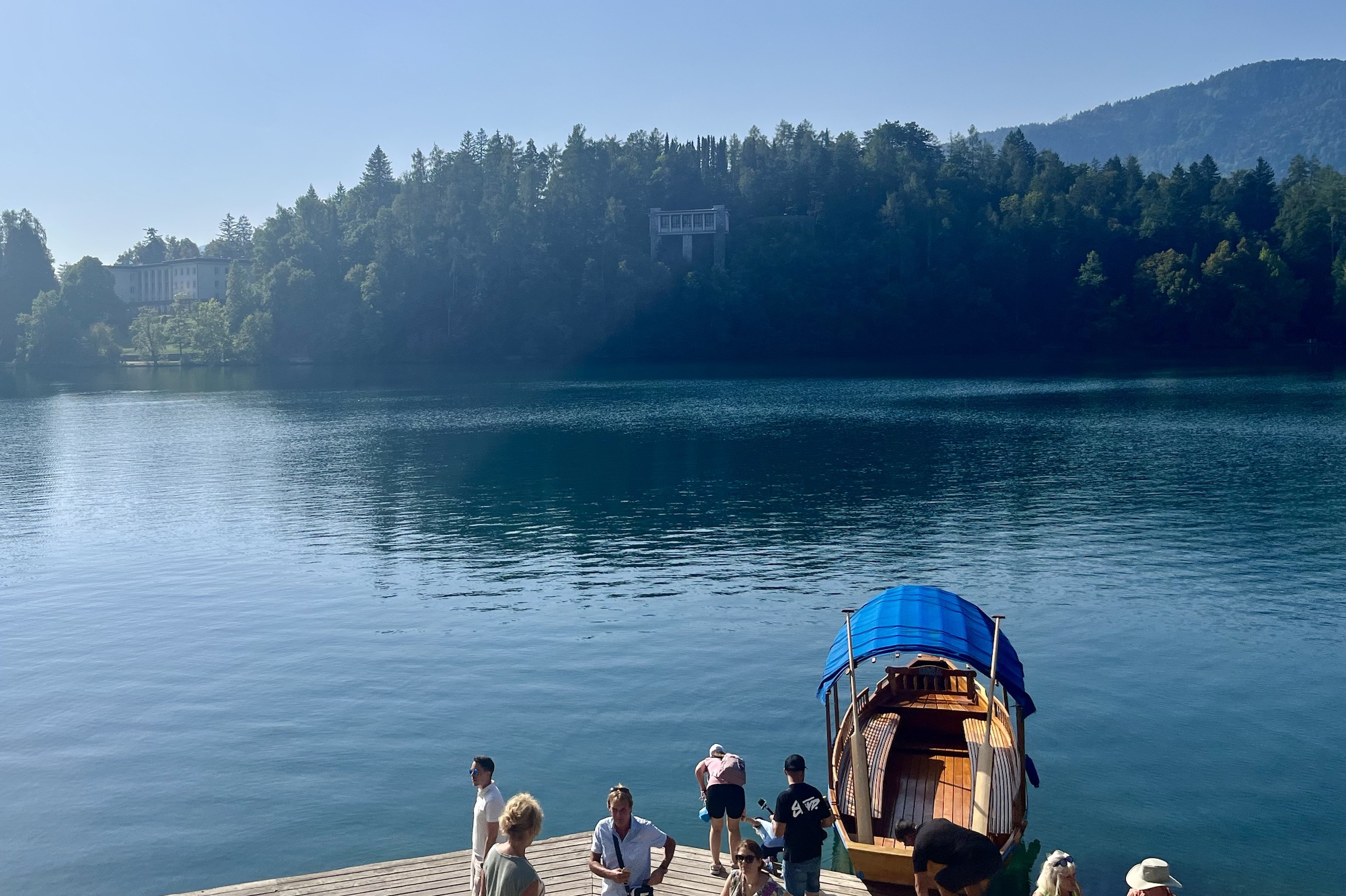 view of lake and pletna on island in Lake Bled