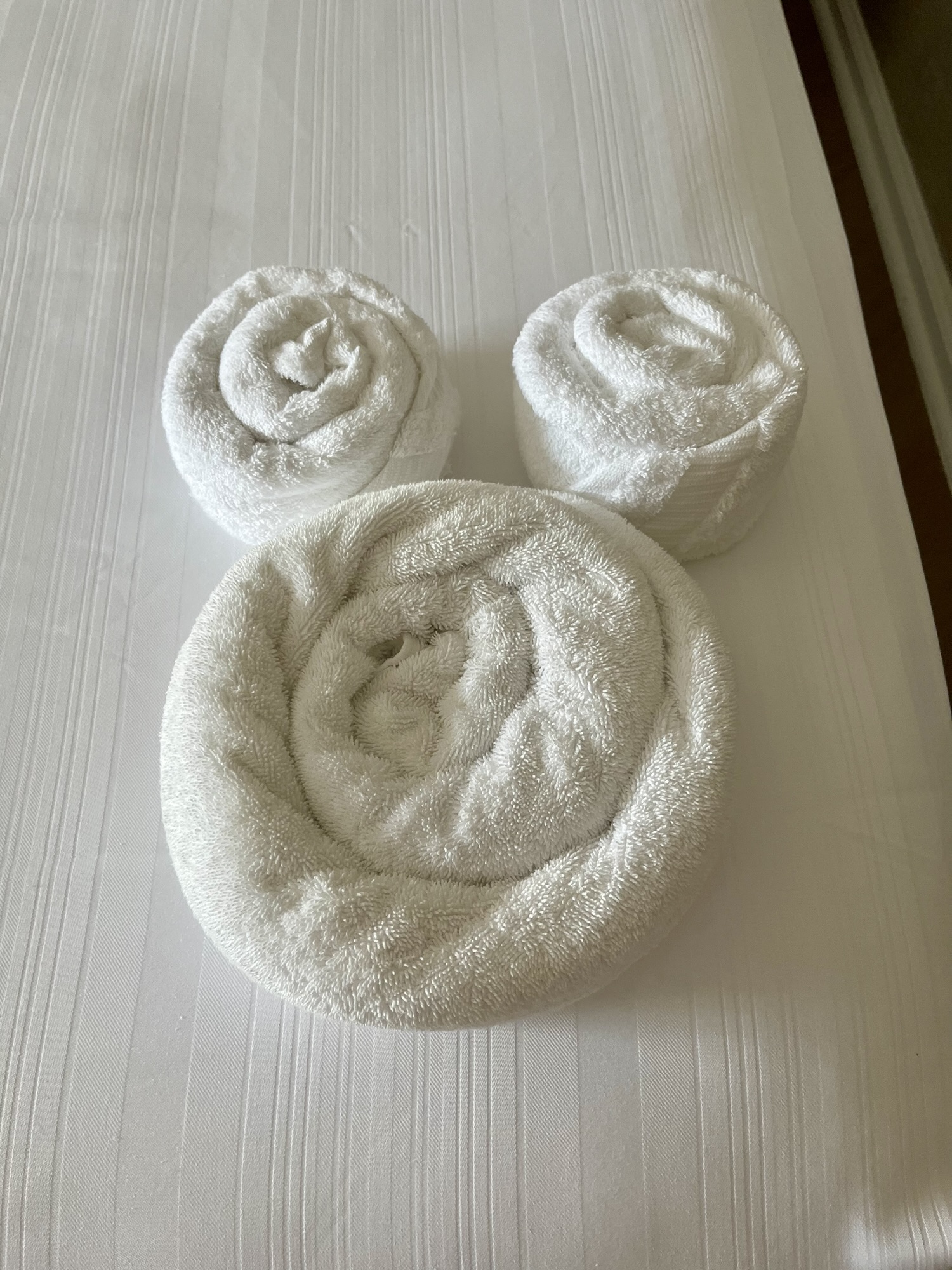 Disney shaped towel on bed at Beach Club Resort in Disney World